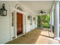 Spacious porch features wooden flooring, lantern fixtures, and views of the outdoor scenery at 43 Montrose Rd, Mount Pleasant, SC 29464