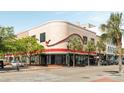 Beautiful Art Deco building in downtown Charleston boasting a rounded corner, tropical trees, and inviting storefronts at 517 King St # 1, Charleston, SC 29403