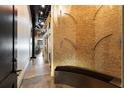 Modern hallway featuring a decorative brick wall and industrial design elements, leading to a spiral staircase at 517 King St # 1, Charleston, SC 29403