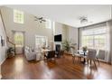 Bright, airy living room with high ceilings, hardwood floors, and plenty of natural light at 547 Nelliefield Trl, Wando, SC 29492