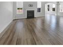 Large living room featuring a fireplace, hardwood floors, and lots of natural light from the windows at 572 Dunswell Dr, Summerville, SC 29486