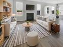 Bright and airy living room featuring stylish furnishings, a fireplace, and ample natural light at 572 Dunswell Dr, Summerville, SC 29486