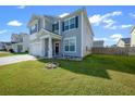 Charming home with manicured lawn, flower garden, gray siding, black shutters, and a cozy front porch at 613 Ravens Wood Rd, Summerville, SC 29486