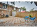 Private backyard features a herringbone tile patio, privacy fence, and blue outdoor furniture at 668 Buckhall Ct # D, Mount Pleasant, SC 29464