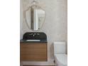 Elegant half-bath with designer floral wallpaper, wood vanity, marble countertop and brass hardware at 924 Trowman Ln, Mount Pleasant, SC 29464