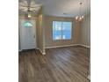 Bright living room featuring durable, modern flooring and ample natural light through front window at 9914 Levenshall Dr, Ladson, SC 29456