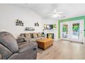 Inviting living room with vaulted ceiling, fireplace, French doors and cozy seating at 1016 Providence Way, Summerville, SC 29483