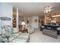 Comfortable living room with plush seating and a view into the dining area and kitchen at 1025 Riverland Woods Pl # 1023, Charleston, SC 29412