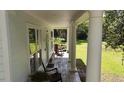 Inviting covered porch with brick flooring and comfortable seating at 104 Waccamaw Dr, Summerville, SC 29485