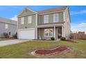 Charming two-story home with an attached two-car garage and manicured landscaping at 1097 Briar Rose Ln, Ladson, SC 29456