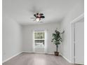 A clean, simple bedroom featuring hardwood floors and natural light from the window at 1300 Park West Blvd # 101, Mount Pleasant, SC 29466