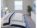 Comfortable bedroom features plush bedding, a bright window, and stylish decor at 1300 Park West Blvd # 406, Mount Pleasant, SC 29466
