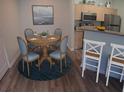 Cozy dining area with seating for four next to the kitchen featuring a breakfast bar at 1300 Park West Blvd # 406, Mount Pleasant, SC 29466