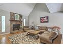 Inviting living room featuring a stone fireplace, vaulted ceiling, and comfortable seating around a stylish coffee table at 141 Bridgecreek Dr, Goose Creek, SC 29445