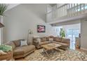 Spacious living area showcasing vaulted ceilings, a cozy sectional sofa, and sliding glass doors for natural light at 141 Bridgecreek Dr, Goose Creek, SC 29445