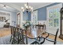 Elegant dining room boasts natural light, fresh paint, classic wainscoting, and ample seating for entertaining at 1531 Capel St, Mount Pleasant, SC 29466