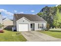 Inviting single-story home featuring a spacious driveway, green lawn, and classic architectural details at 157 Tyger St, Summerville, SC 29485
