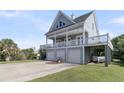 Beautiful home featuring a three-car garage, covered area, and a large balcony with lovely views at 1595 Teal Marsh Rd, Charleston, SC 29412