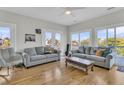 Bright living room featuring hardwood floors, comfortable seating, and access to a balcony at 1595 Teal Marsh Rd, Charleston, SC 29412