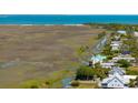 Aerial view of a waterfront home with canals and a stunning marsh view at 1676 E Ashley Ave, Folly Beach, SC 29439