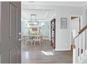Warm and inviting foyer with hardwood floors, elegant lighting, and a view of the dining room at 1907 Mossdale Dr, Johns Island, SC 29455