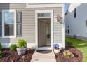 Inviting entryway with stylish decor, plants, and a freshly painted front door with house number at 1907 Mossdale Dr, Johns Island, SC 29455