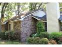 Side view of a cozy brick house with manicured bushes in the yard at 20 Anderson Ave, Charleston, SC 29412