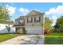 Charming two-story home featuring a manicured lawn, a driveway, and an attached two-car garage at 2007 Robin Wood Blvd, Moncks Corner, SC 29461