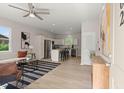 Bright open-concept living room and kitchen with stainless steel appliances and bar seating at 202 Resinwood Rd, Moncks Corner, SC 29461