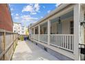 Inviting side porch featuring white railings, a sky blue ceiling, and a private outdoor space at 22 Sheppard St, Charleston, SC 29403