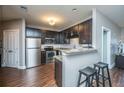 Modern kitchen with stainless steel appliances, granite countertops, and dark wood cabinets at 2244 Ashley Crossing Drive Dr # 621, Charleston, SC 29414