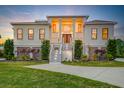 Elegant two-story home with a manicured lawn, showcasing a grand entrance and inviting curb appeal at 2732 Canebreak Ln, Mount Pleasant, SC 29466