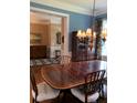 Dining room with hardwood floors, wainscotting and elegant lighting with a view to the entry hall at 3017 Ashburton Way, Mount Pleasant, SC 29466