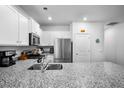 Bright kitchen featuring white cabinets, granite countertops, stainless steel appliances, and modern fixtures at 303 Feldspar Ln, Ladson, SC 29456