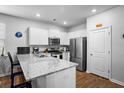 Bright kitchen featuring white cabinets, granite countertops, stainless steel appliances, and modern fixtures at 303 Feldspar Ln, Ladson, SC 29456