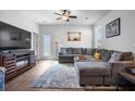 Inviting living room with a plush gray sectional, stylish decor, and natural light streaming through the window at 303 Feldspar Ln, Ladson, SC 29456