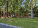 Scenic backyard features mature trees, lush lawn and manicured landscaping at 304 Pimpernel St, Summerville, SC 29483