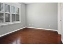 Bright bedroom features hardwood floors and white-trimmed windows with shutter blinds at 304 Pimpernel St, Summerville, SC 29483