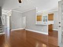 Spacious living room flows into the kitchen with breakfast bar and hardwood floors at 304 Pimpernel St, Summerville, SC 29483