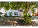 A well kept home with an inviting front yard, mature trees, and a cozy, covered entrance at 3222 Morningdale Dr, Mount Pleasant, SC 29466