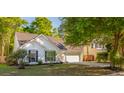 Traditional home boasting a manicured lawn, mature trees, and a welcoming two-car garage at 3222 Morningdale Dr, Mount Pleasant, SC 29466