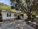 Charming one-story home with white siding, front porch, and a concrete driveway at 3342 Habitat Blvd Blvd, Johns Island, SC 29455