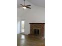 Spacious living room boasts a brick fireplace, ceiling fan, and access to the backyard at 4153 Hickory Ln, Ladson, SC 29456