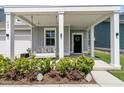 Inviting front porch with swing, decorative wreath, and charming Easter decorations, perfect for relaxing at 427 W Respite Ln, Summerville, SC 29483