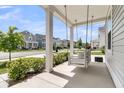 Relaxing front porch with swing and view of a picturesque street with beautiful homes at 427 W Respite Ln, Summerville, SC 29483