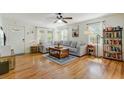 Inviting living room featuring hardwood floors, a comfortable gray sofa, and lots of natural light at 4709 Marlboro Pl, North Charleston, SC 29405