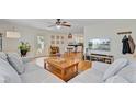 Open-concept living area featuring a comfortable sofa, hardwood flooring, and a view of the kitchen at 4709 Marlboro Pl, North Charleston, SC 29405