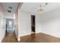 View of living room featuring hardwood floors and a dining area in need of renovation at 4747 Lewis And Clark Trl, Summerville, SC 29485