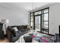 Bright living room with large windows, a comfortable sectional sofa, modern lighting, and stylish decor at 5 Gadsdenboro St # 416, Charleston, SC 29401