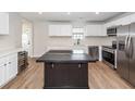 Kitchen with stainless steel appliances, stylish island, stone countertops, and ample cabinet space at 521 Savannah Rd, Ladson, SC 29456
